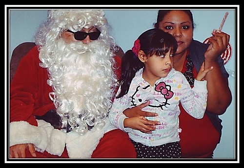 Santa posing with a Mother and her Daughter